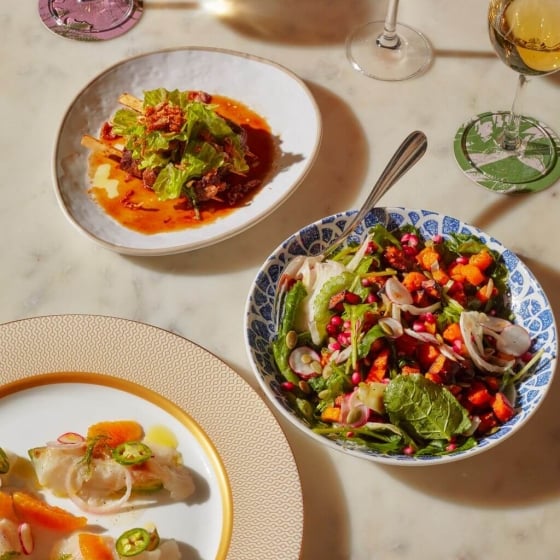 Colorful salads and cocktails on a white table.