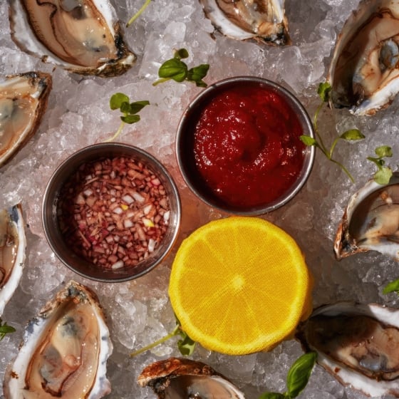 Oysters on ice with mignonette and lemon.