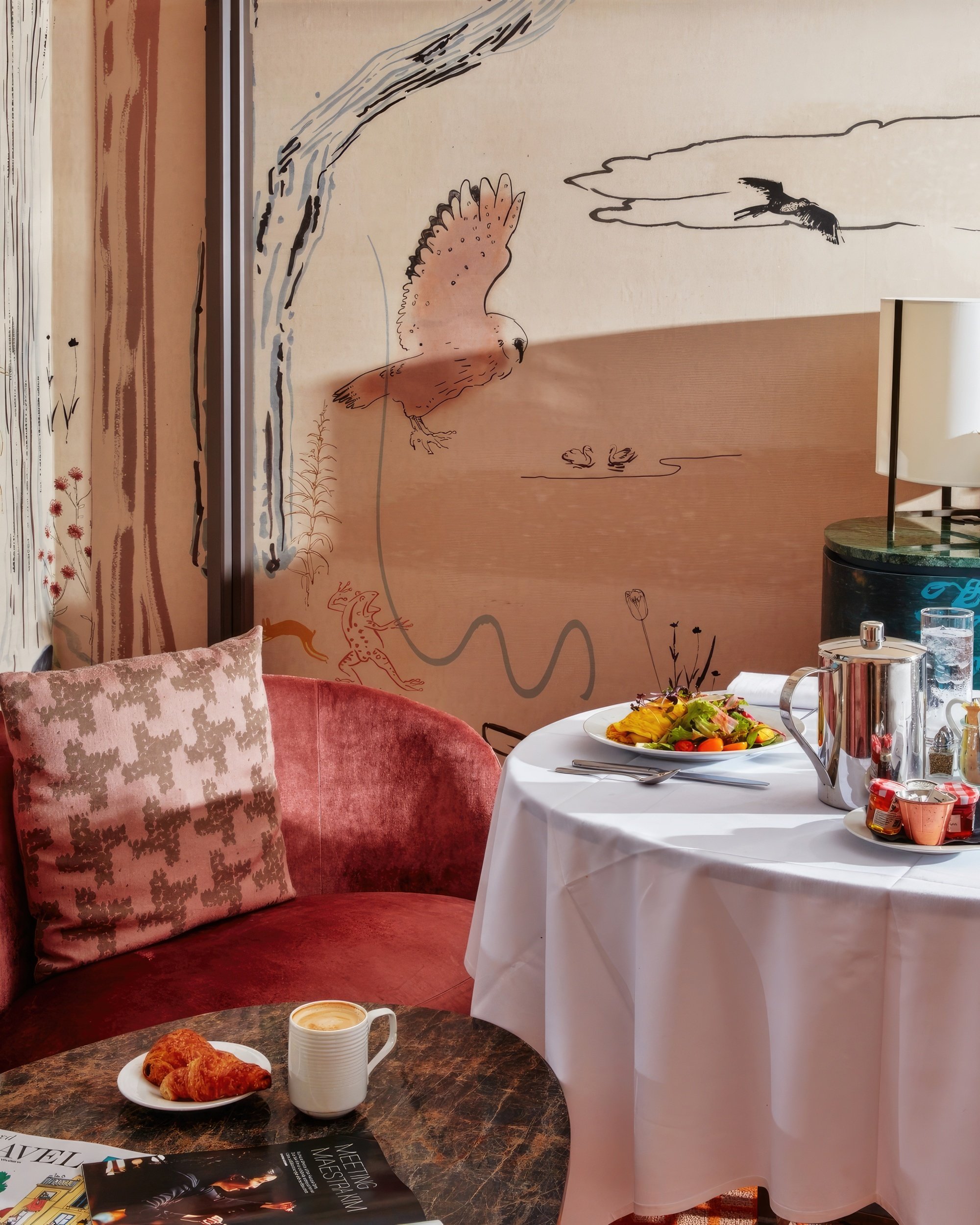 In-room dining breakfast consisting of lattes, croissants, fruit, at a small seating area in a room at Park Lane New York.