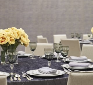 A table set with china, cutlery and glasses for an event.