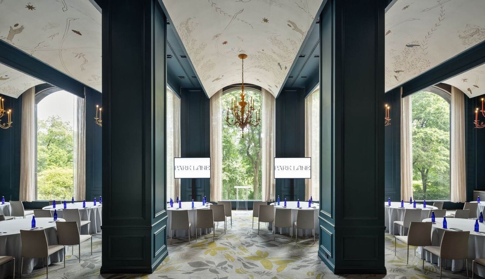 An elegant meeting room with tables set up to watch a presentation.