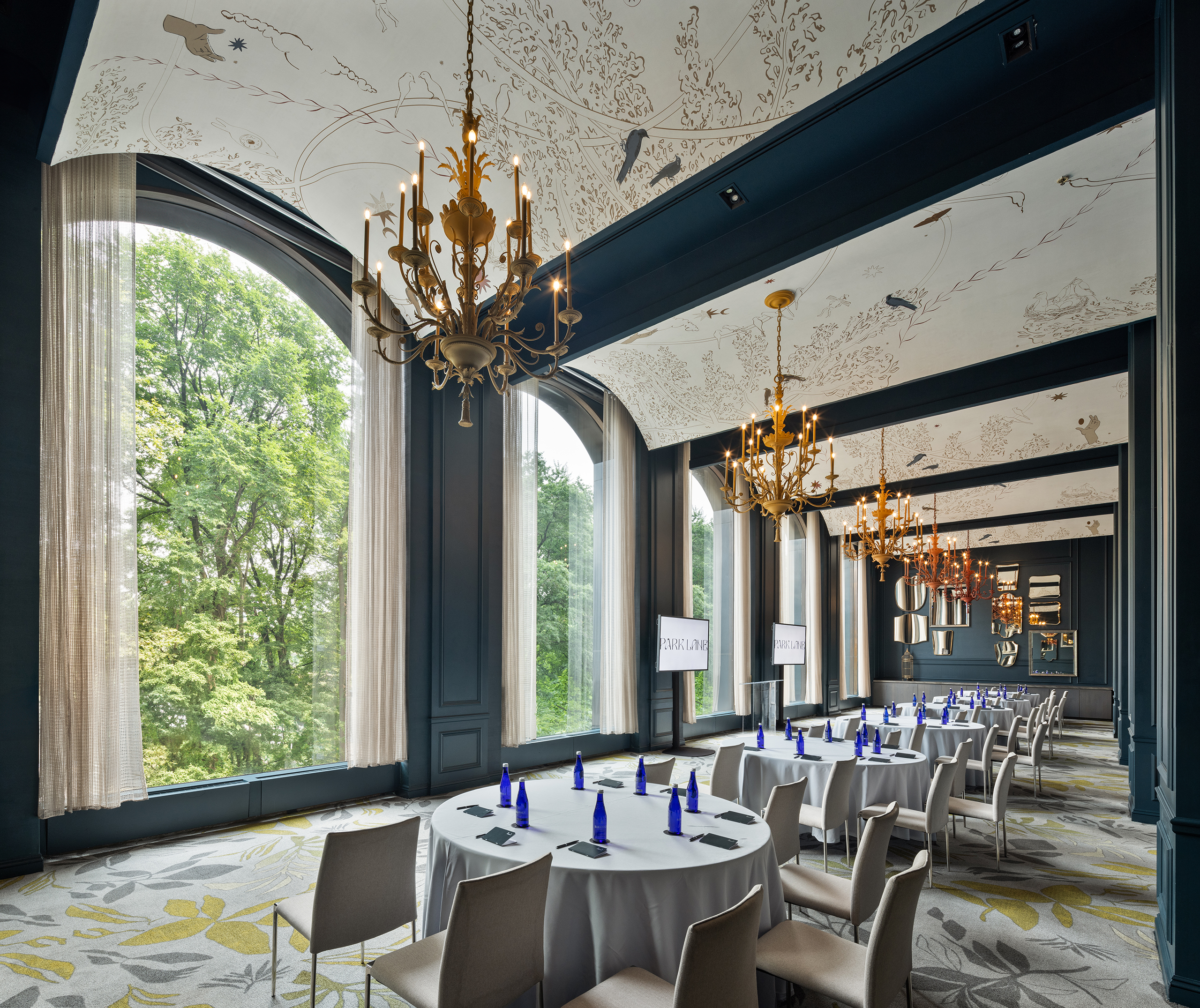 An elegant meeting room with tables set up to watch a presentation.