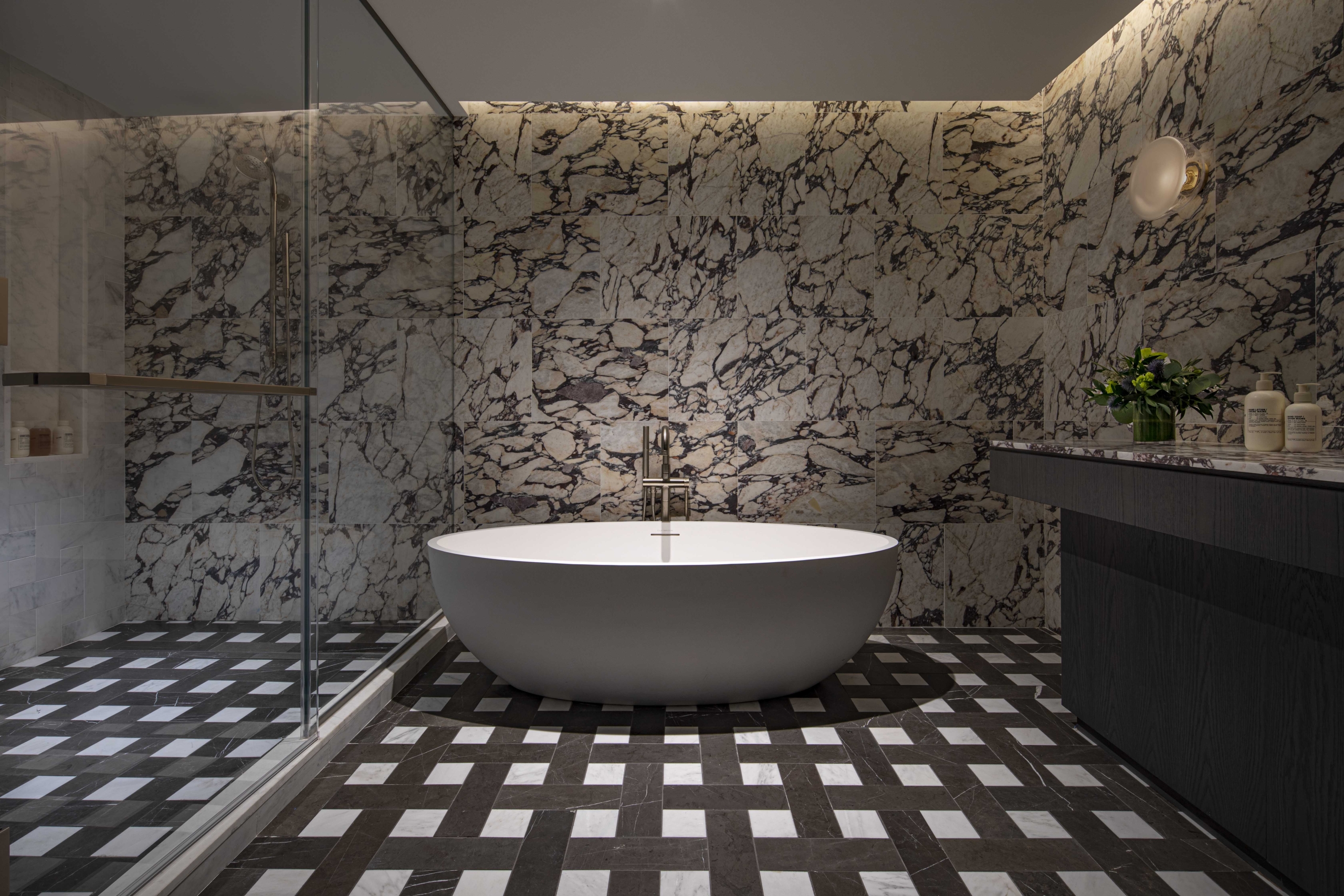 A deep tub next to a spacious walk in shower in the Belvedere Suite at Park Lane New York.