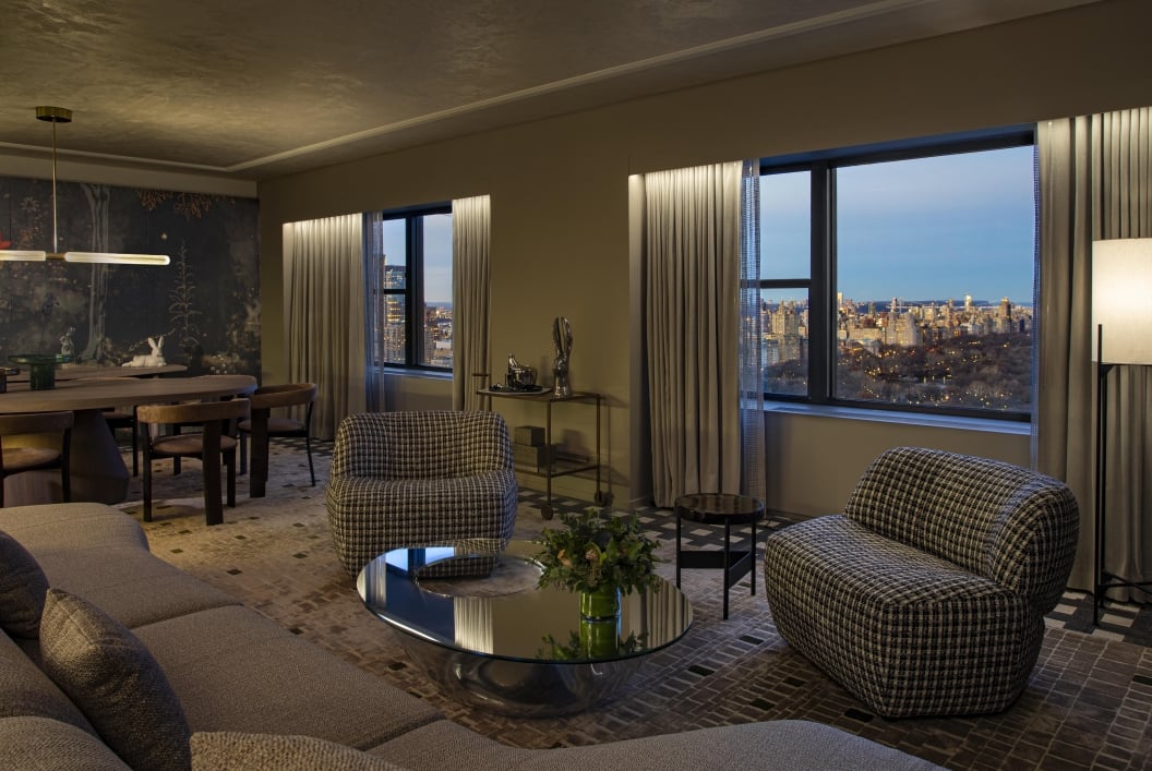 A spacious seating area and dining area in the Belvedere Suite overlooking Central Park at Park Lane New York.