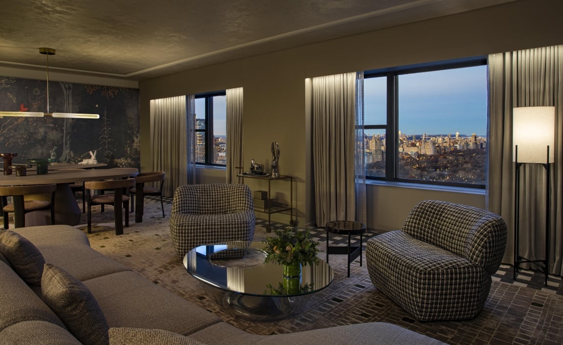 A spacious seating area and dining area in the Belvedere Suite overlooking Central Park at Park Lane New York.