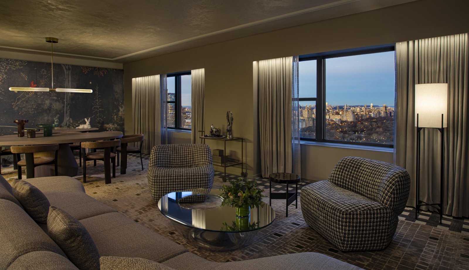 A spacious seating area and dining area in the Belvedere Suite overlooking Central Park at Park Lane New York.