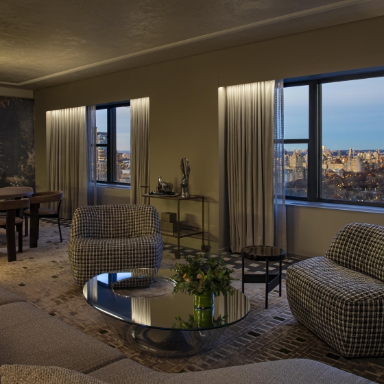 A spacious seating area and dining area in the Belvedere Suite overlooking Central Park at Park Lane New York.