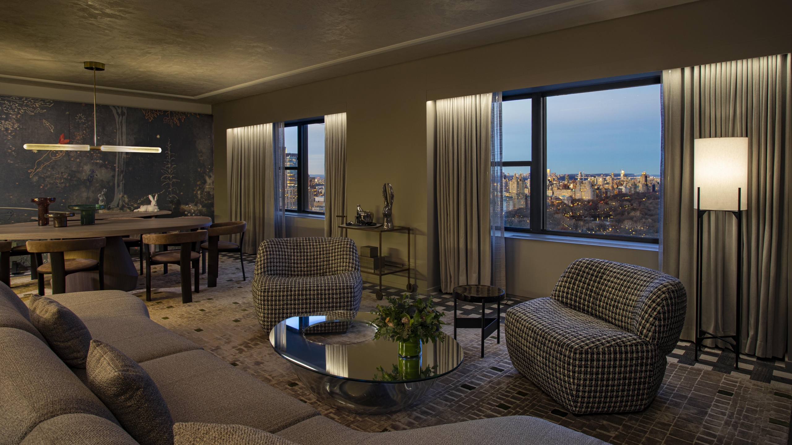 A spacious seating area and dining area in the Belvedere Suite overlooking Central Park at Park Lane New York.