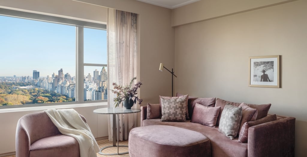 A couch, ottoman and chair in a suite overlooking Central Park at Park Lane New York.