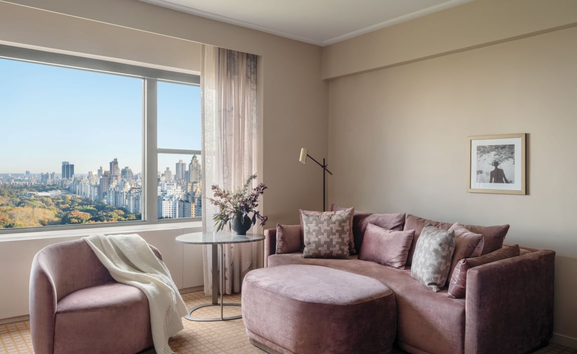 A couch, ottoman and chair in a suite overlooking Central Park at Park Lane New York.