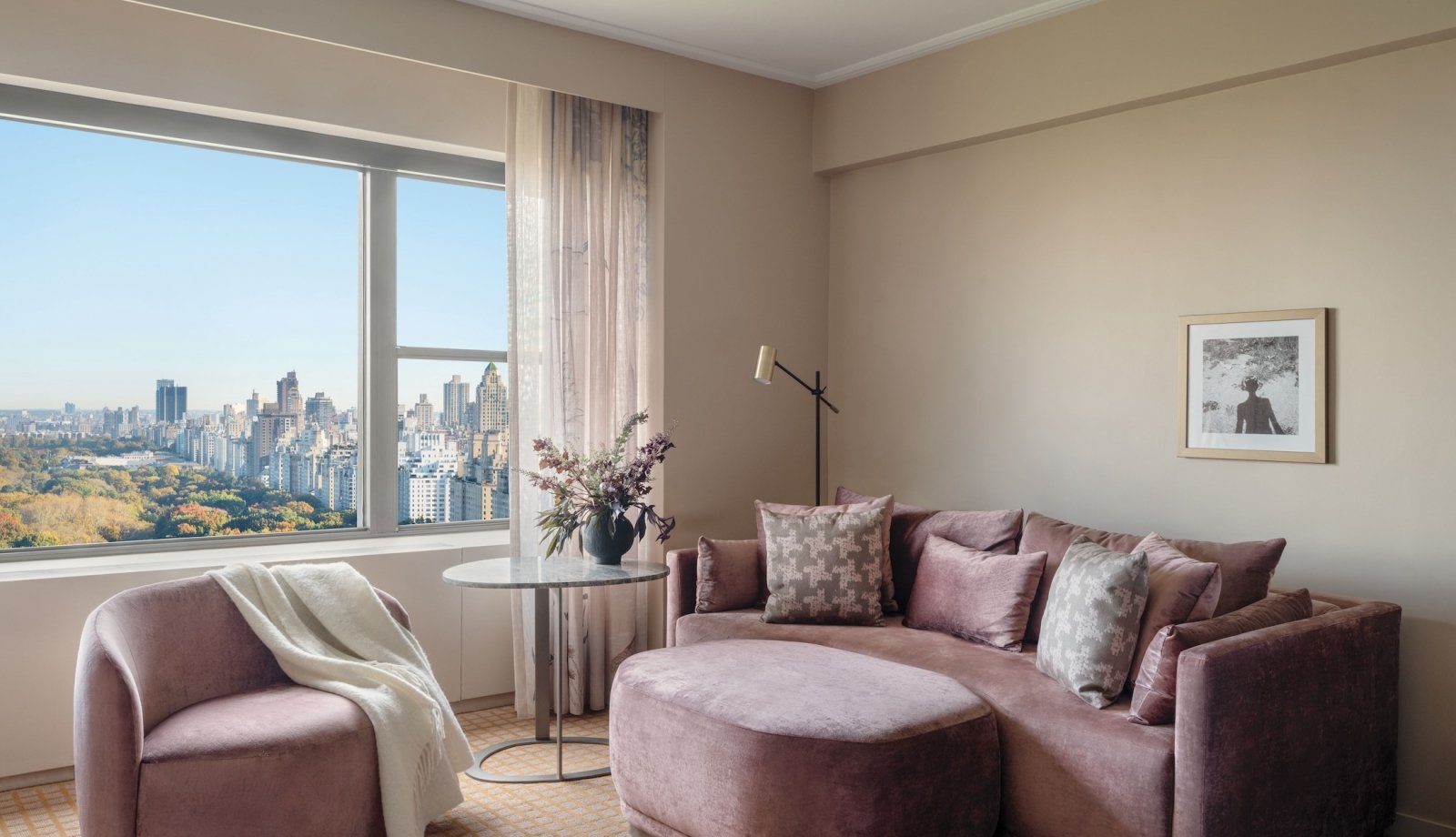 A couch, ottoman and chair in a suite overlooking Central Park at Park Lane New York.