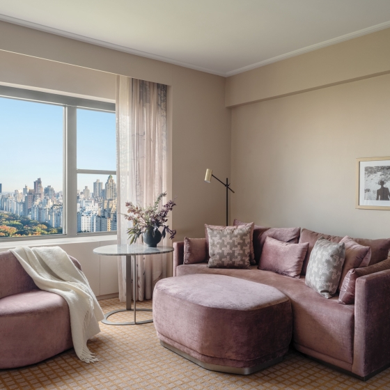 A couch, ottoman and chair in a suite overlooking Central Park at Park Lane New York.