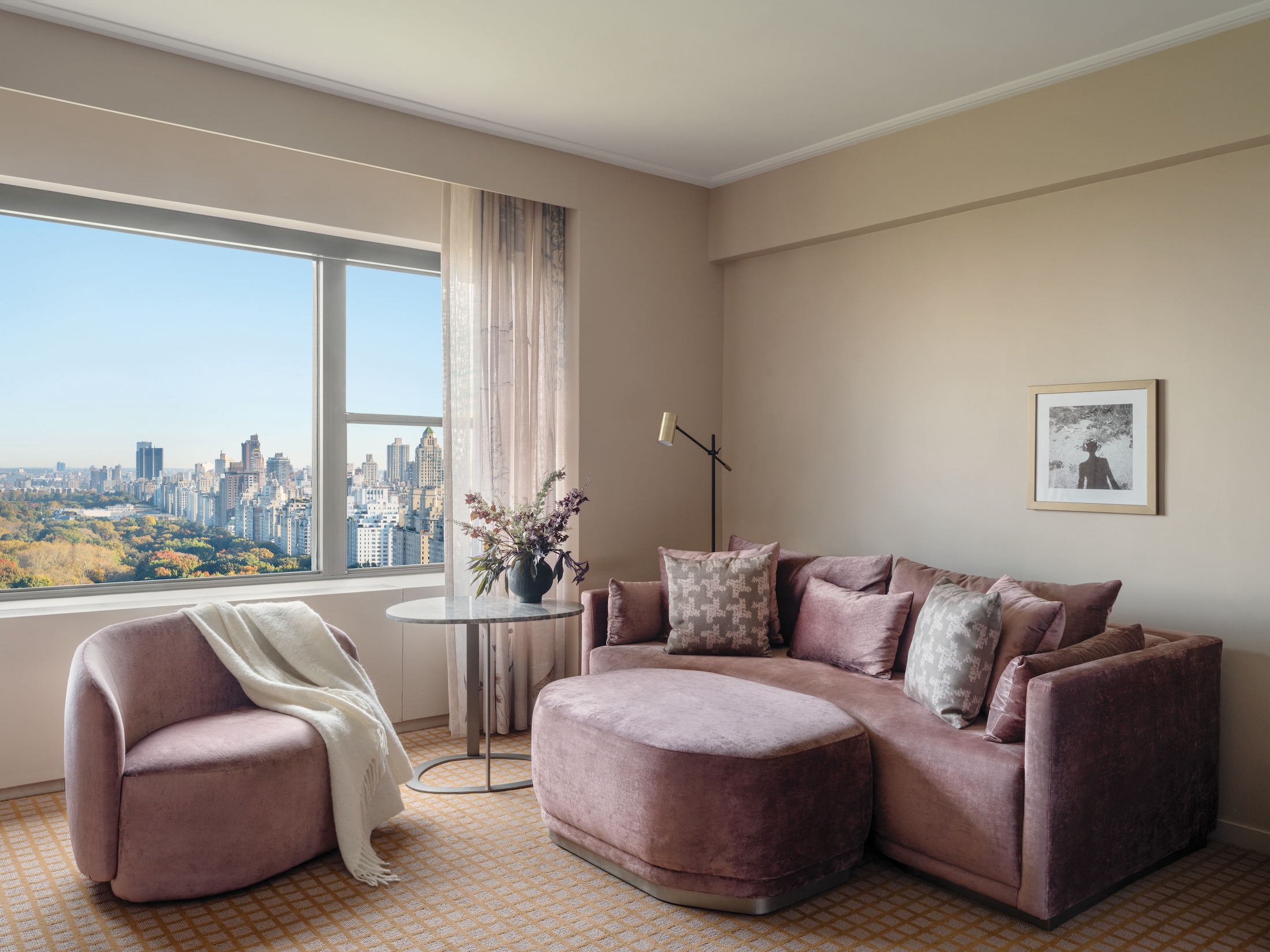 A couch, ottoman and chair in a suite overlooking Central Park at Park Lane New York.