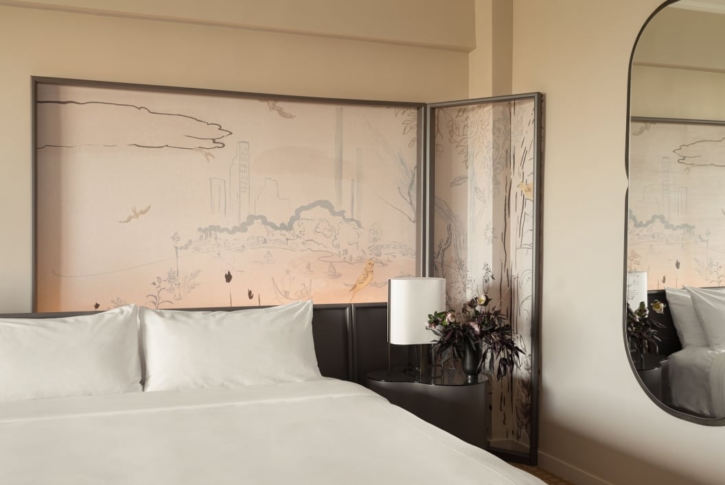 A king bed and painted mural in a suite at Park Lane New York.