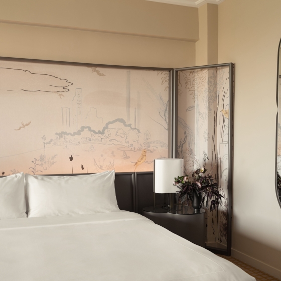 A king bed and painted mural in a suite at Park Lane New York.