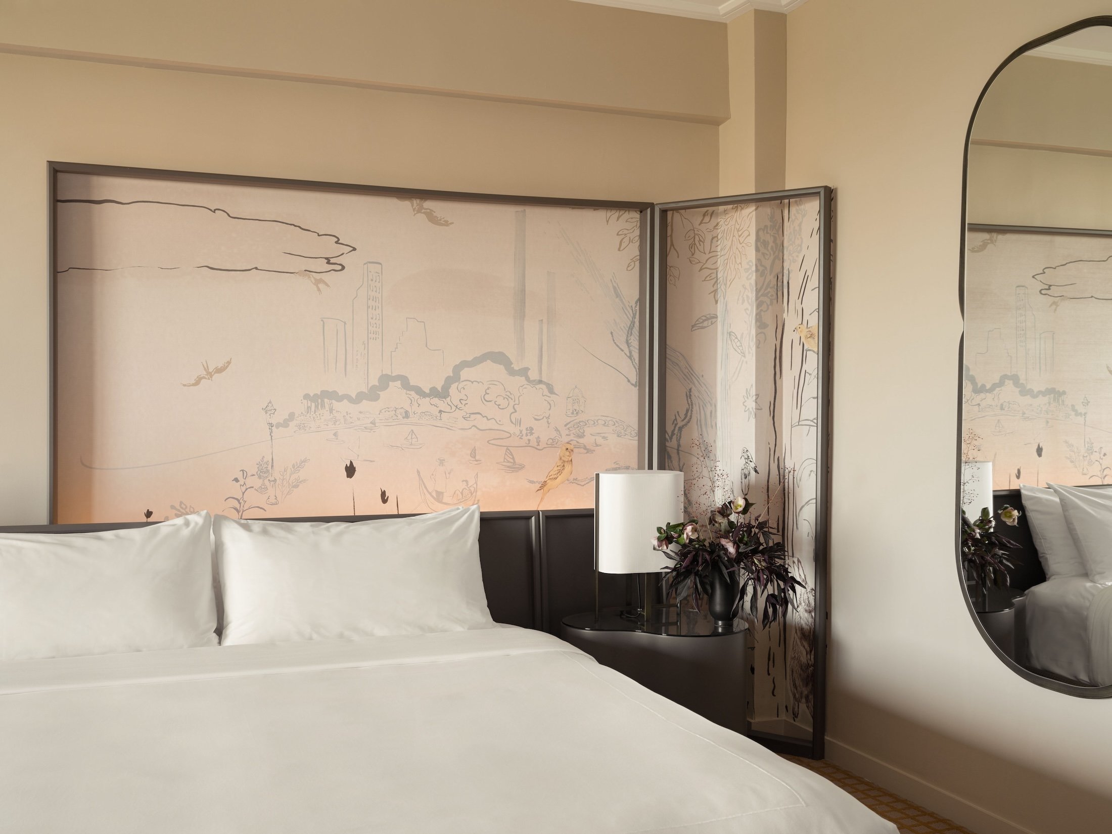 A king bed and painted mural in a suite at Park Lane New York.