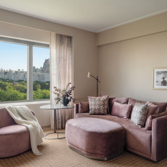 A couch, ottoman and chair in a suite overlooking Central Park at Park Lane New York.