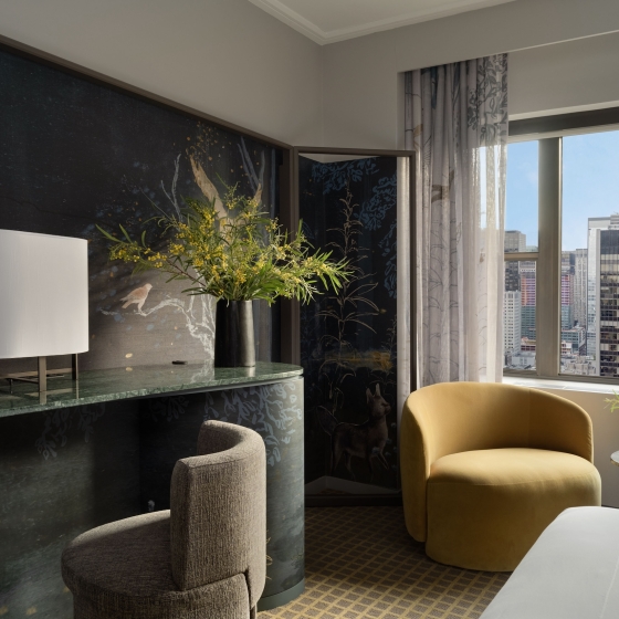 The desk and seating area of a room overlooking the city at Park Lane New York.