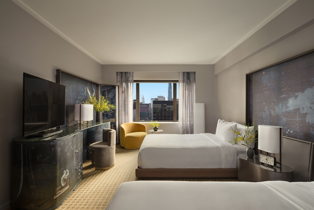 A two queen room with desk and seating area overlooking the city at Park Lane New York.