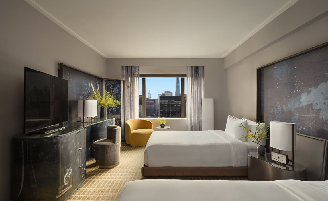 A two queen room with desk and seating area overlooking the city at Park Lane New York.