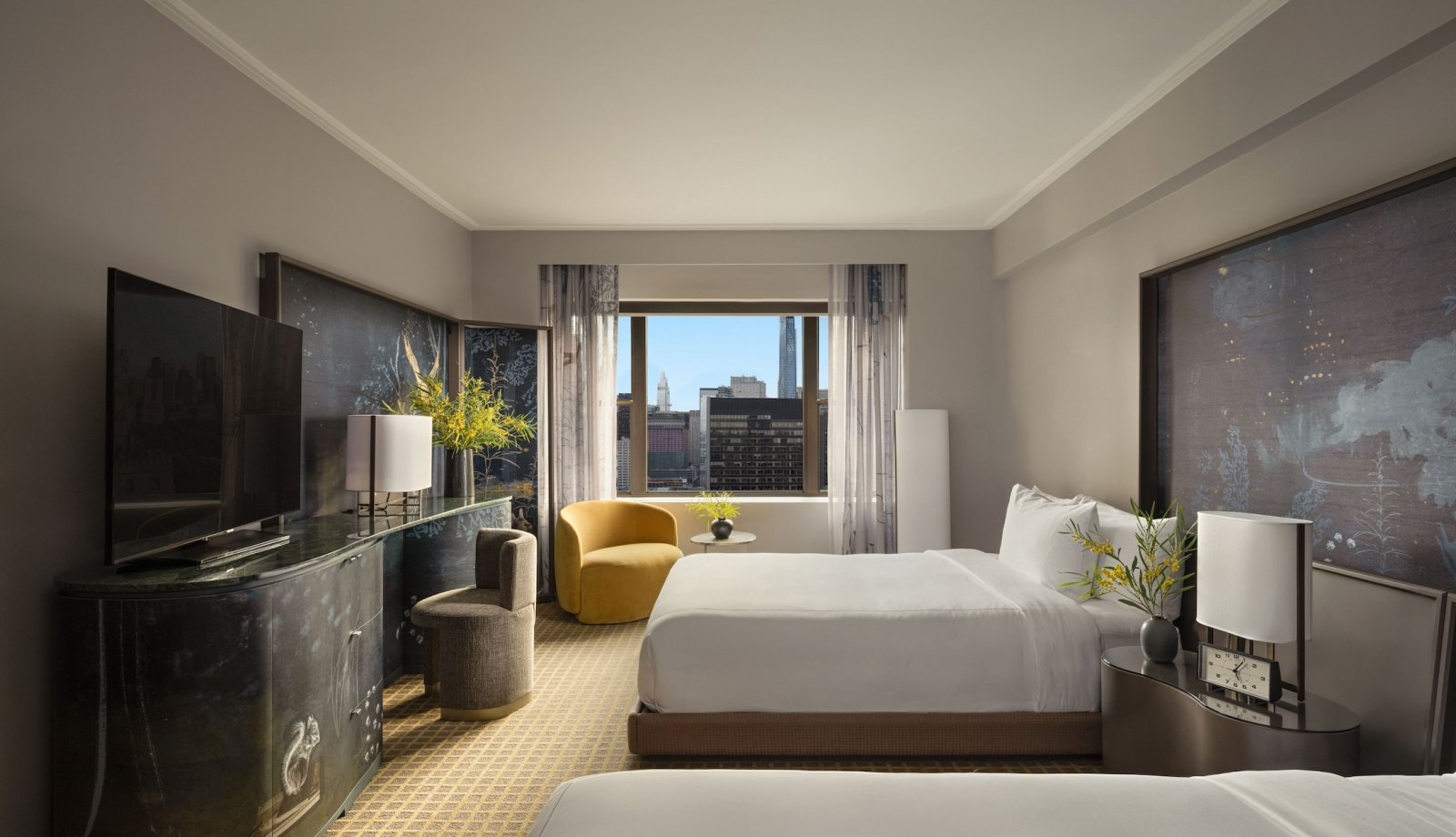 A two queen room with desk and seating area overlooking the city at Park Lane New York.