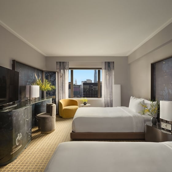 A two queen room with desk and seating area overlooking the city at Park Lane New York.