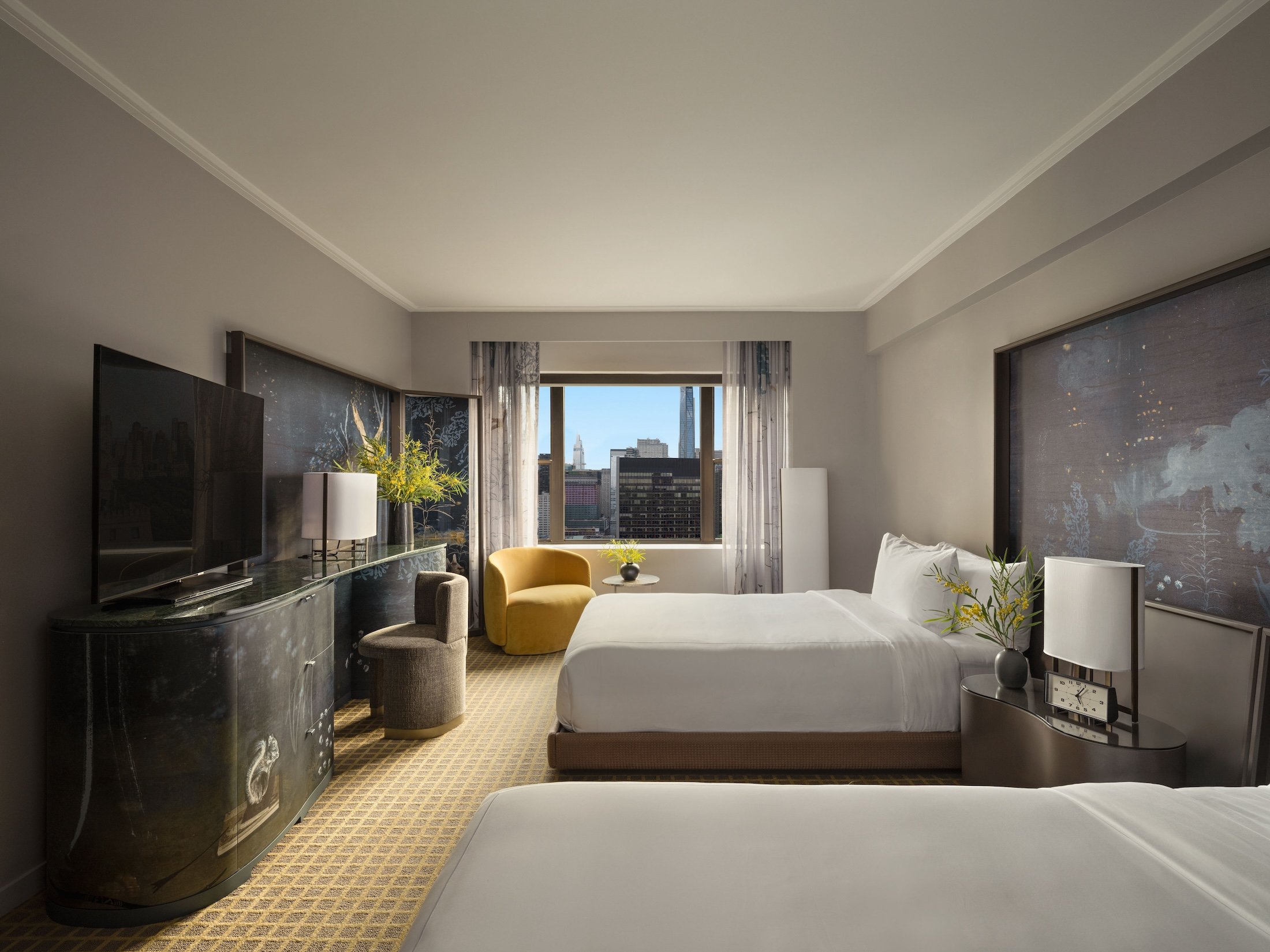 A two queen room with desk and seating area overlooking the city at Park Lane New York.