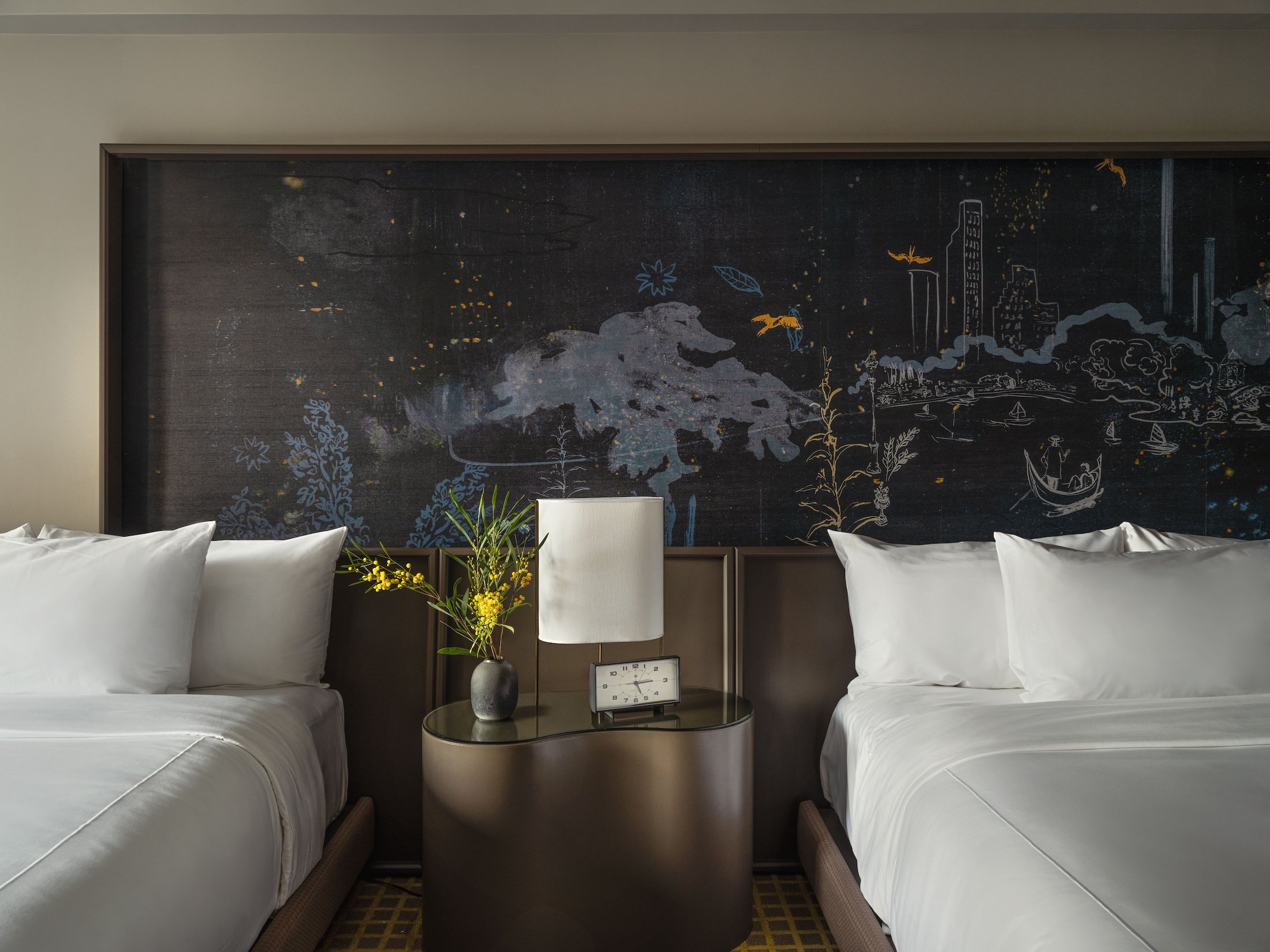 Two queen beds against a hand painted mural at Park Lane New York.