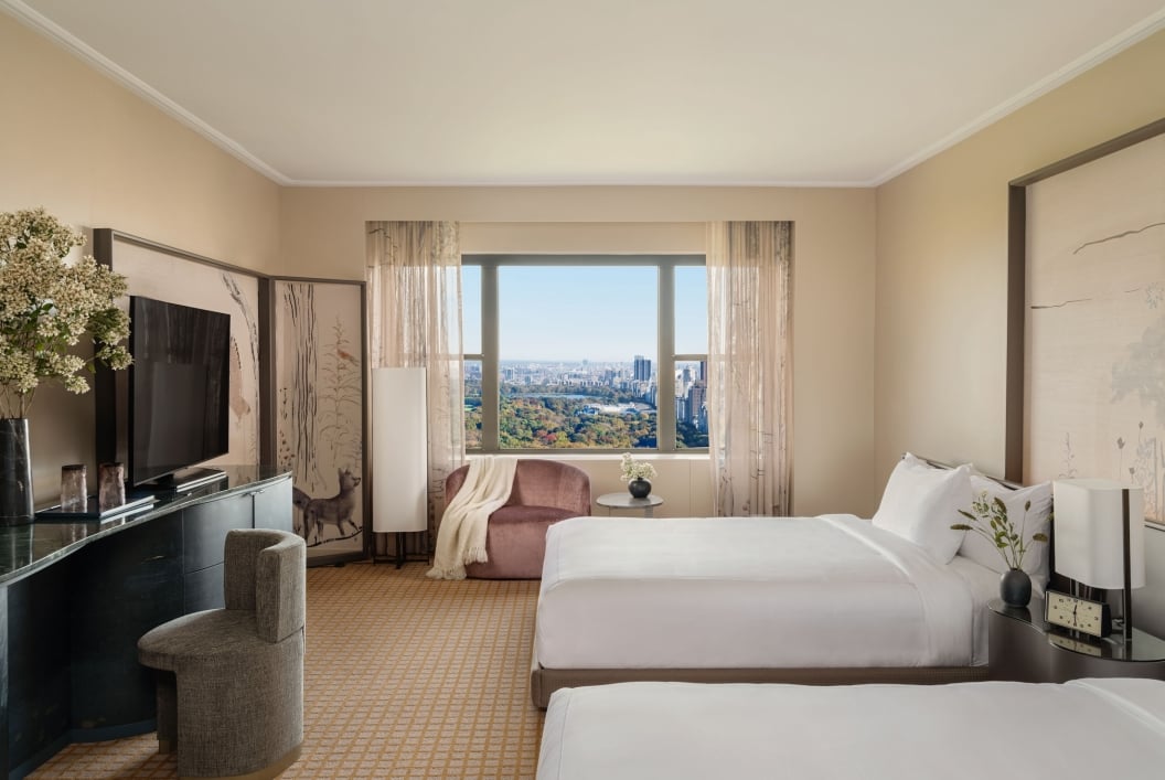 A two queen room with desk and seating area overlooking Central Park at Park Lane New York.