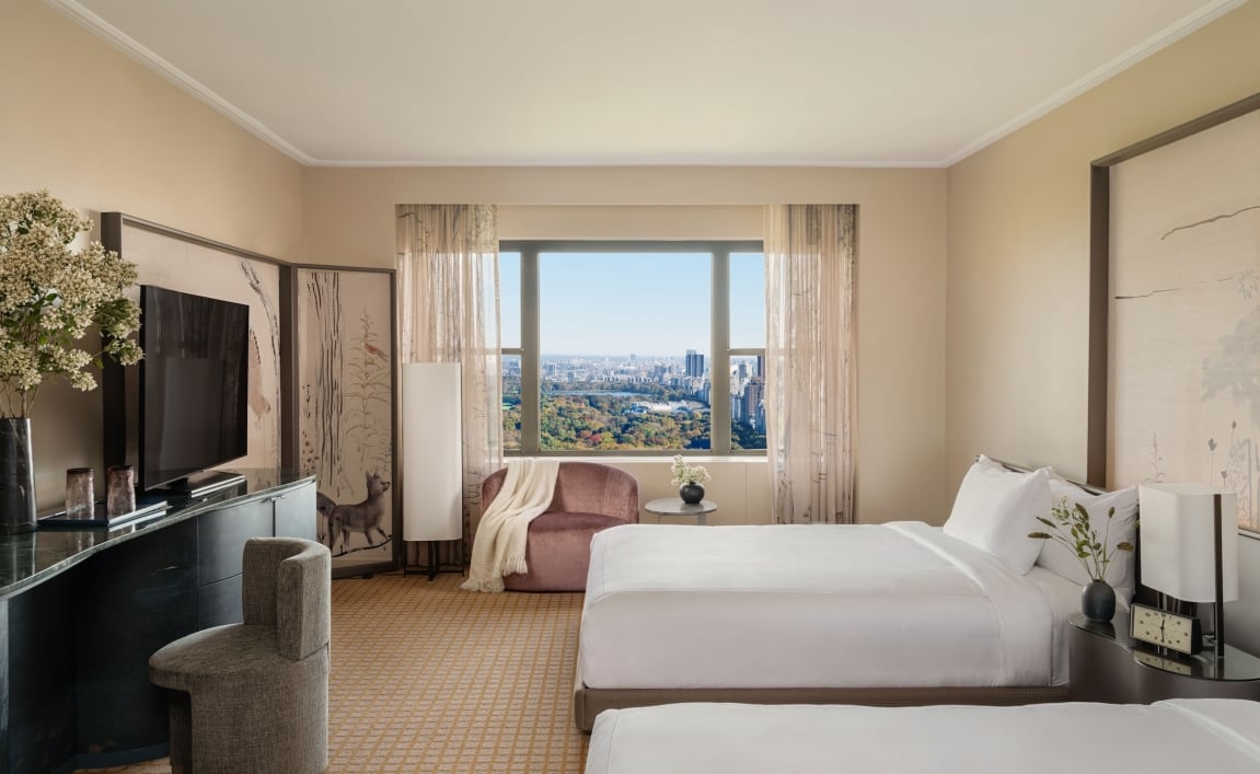 A two queen room with desk and seating area overlooking Central Park at Park Lane New York.