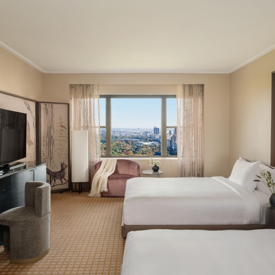 A two queen room with desk and seating area overlooking Central Park at Park Lane New York.