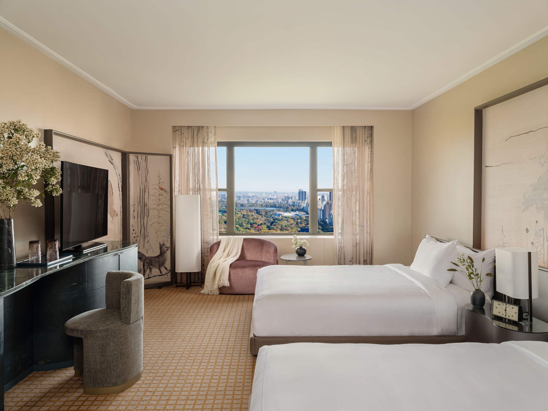 A two queen room with desk and seating area overlooking Central Park at Park Lane New York.