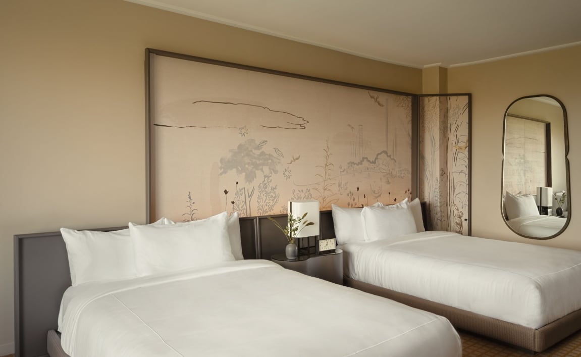 Two queen beds against a hand painted mural at Park Lane New York.