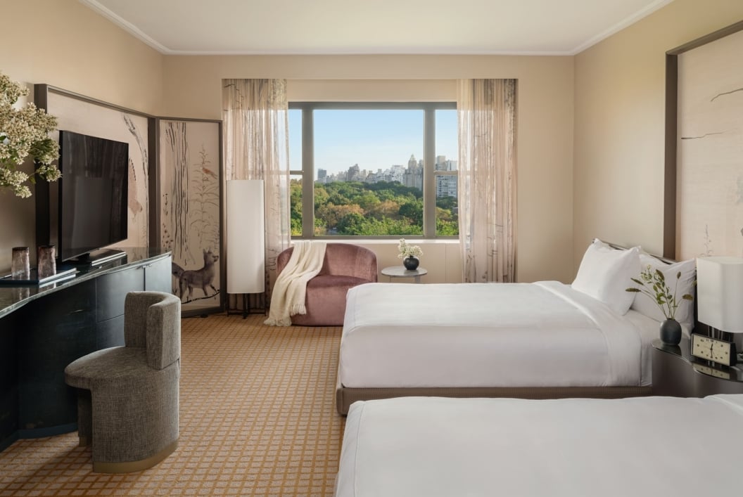 A two queen room with desk and seating area overlooking Central Park at Park Lane New York.