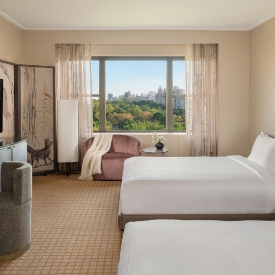 A two queen room with desk and seating area overlooking Central Park at Park Lane New York.