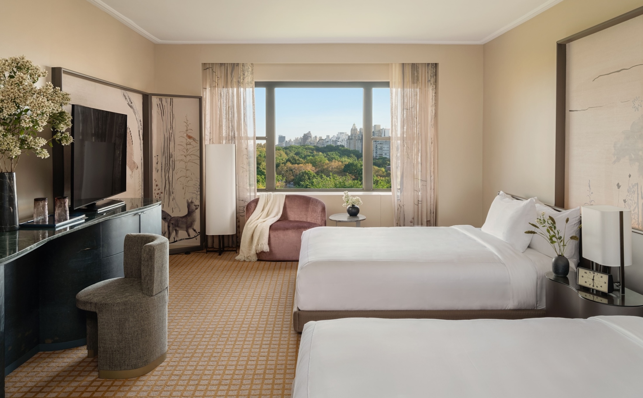 A two queen room with desk and seating area overlooking Central Park at Park Lane New York.